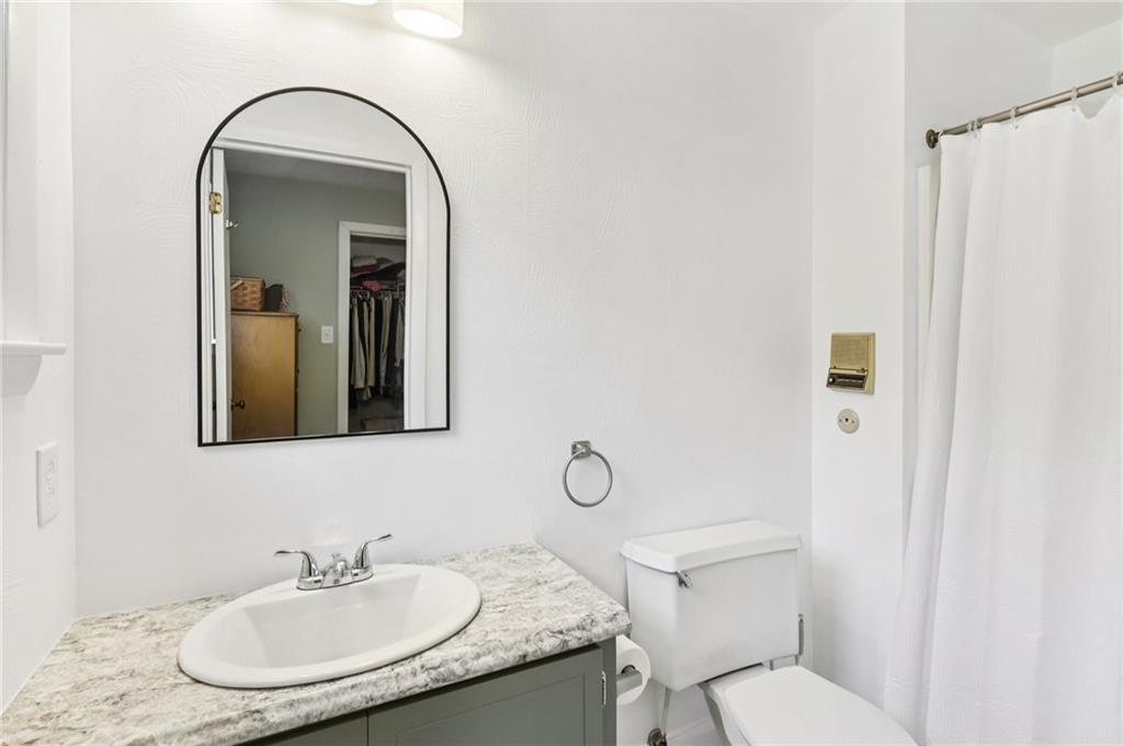 748 Four Mile Run Road Ligonier, PA 15658 - Photo 43 of 49 a bathroom with a granite countertop toilet a sink and mirror