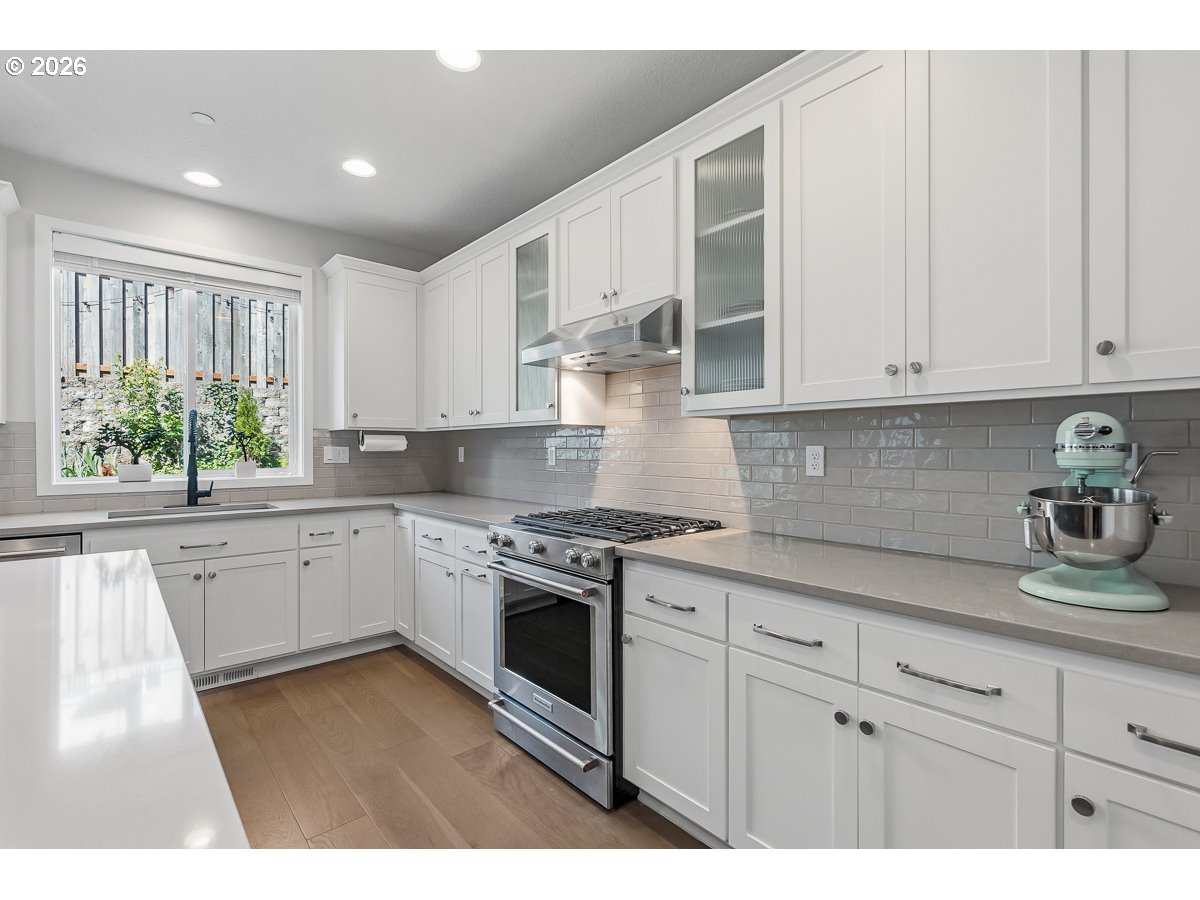 16275 Southwest Jade View Way Beaverton, OR 97007 - Photo 8 of 34 a kitchen with granite countertop white cabinets and white appliances