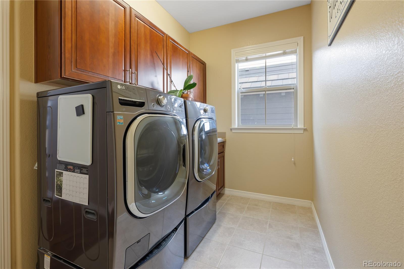 10681 Sundial Rim Road Highlands Ranch, CO 80126 - Photo 14 of 45 a utility room with dryer and washer
