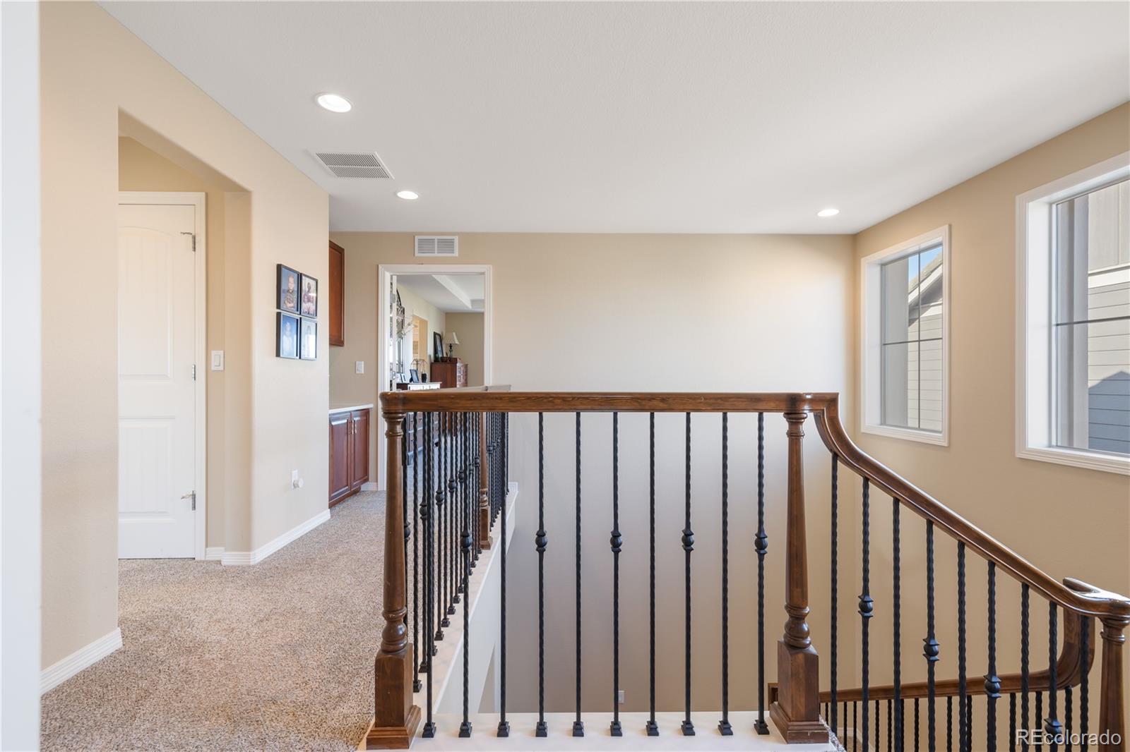 10681 Sundial Rim Road Highlands Ranch, CO 80126 - Photo 16 of 45 a view of a hallway with windows