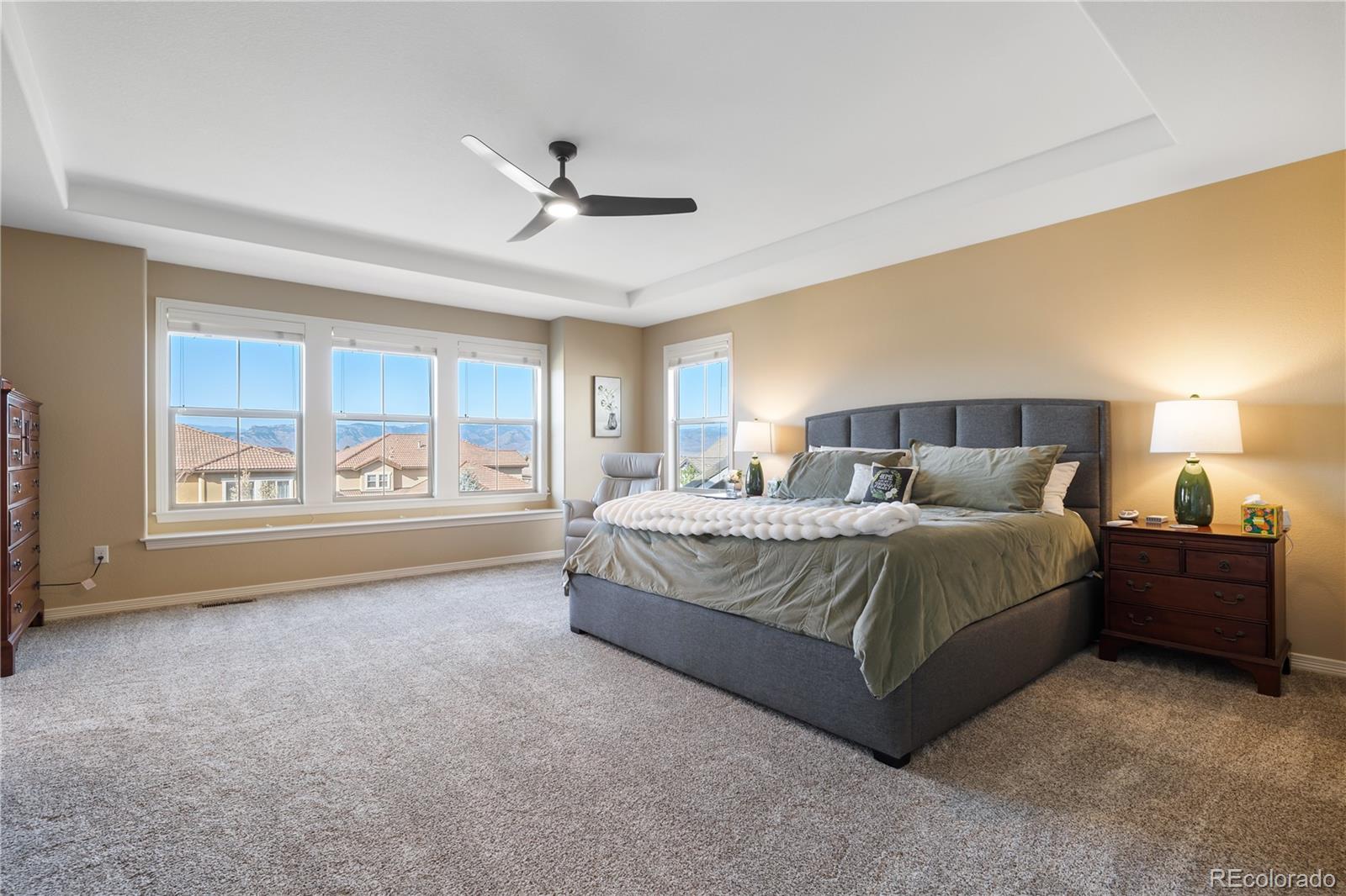 10681 Sundial Rim Road Highlands Ranch, CO 80126 - Photo 17 of 45 a spacious bedroom with a large bed and a large window