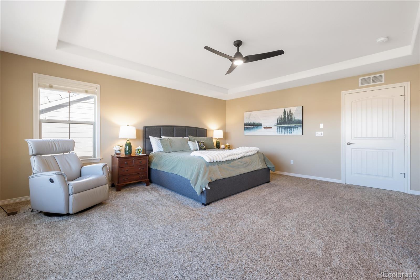 10681 Sundial Rim Road Highlands Ranch, CO 80126 - Photo 20 of 45 a bedroom with a bed couch and window