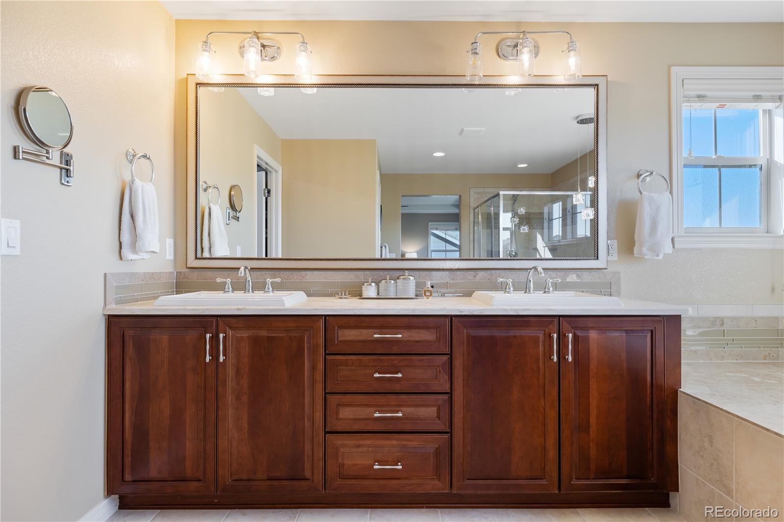 10681 Sundial Rim Road Highlands Ranch, CO 80126 - Photo 22 of 45 a bathroom with a sink and a mirror