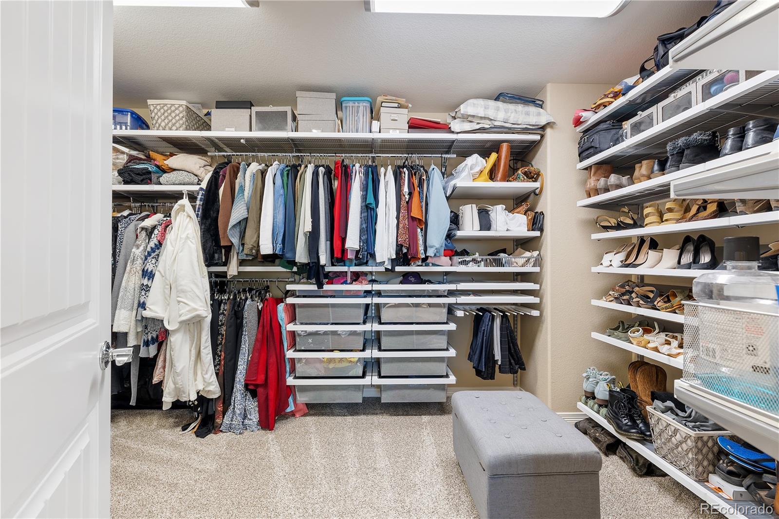 10681 Sundial Rim Road Highlands Ranch, CO 80126 - Photo 25 of 45 a view of walk in closet with clothes and shoes