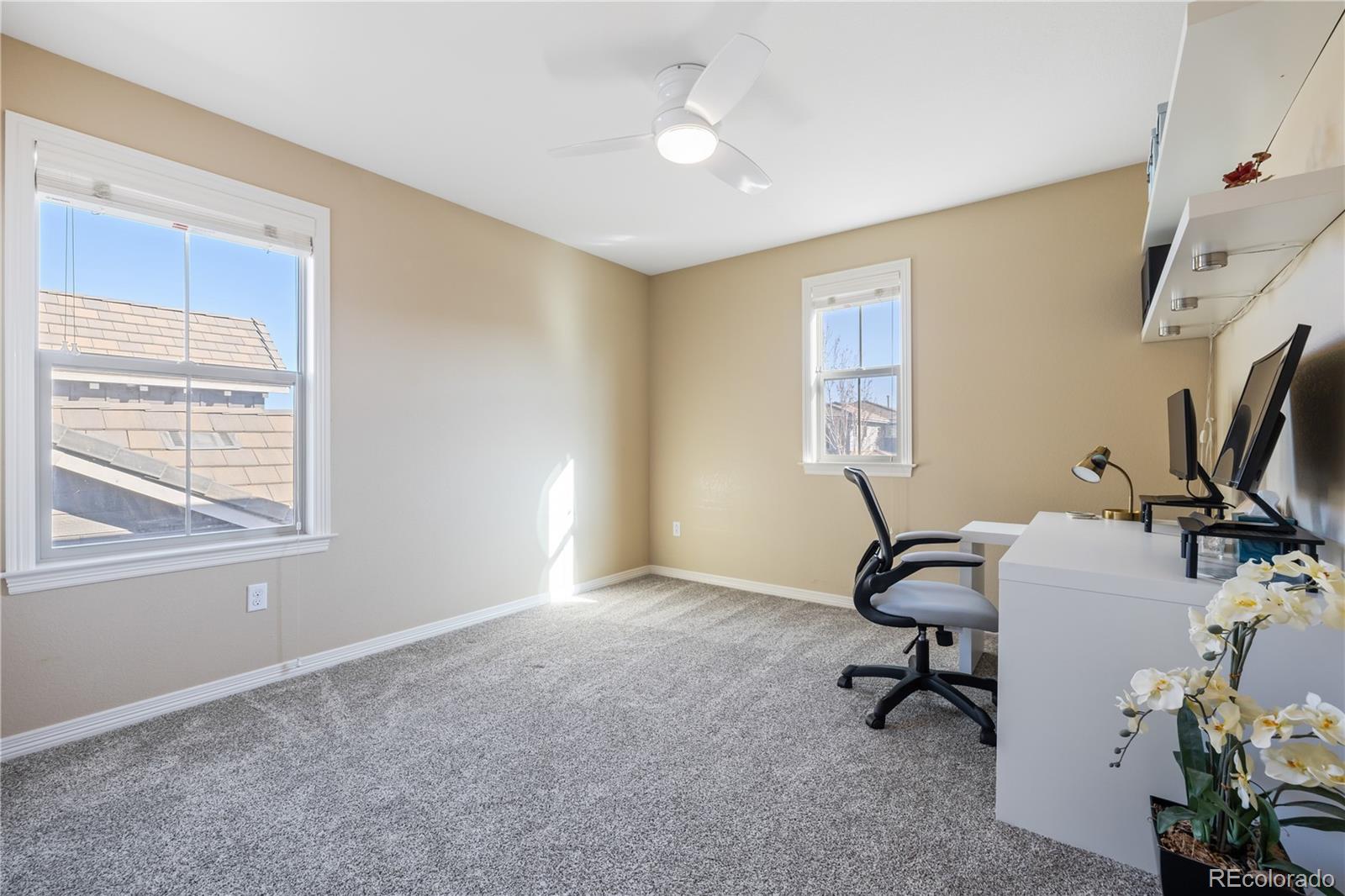 10681 Sundial Rim Road Highlands Ranch, CO 80126 - Photo 26 of 45 a view of a workspace with furniture and a window