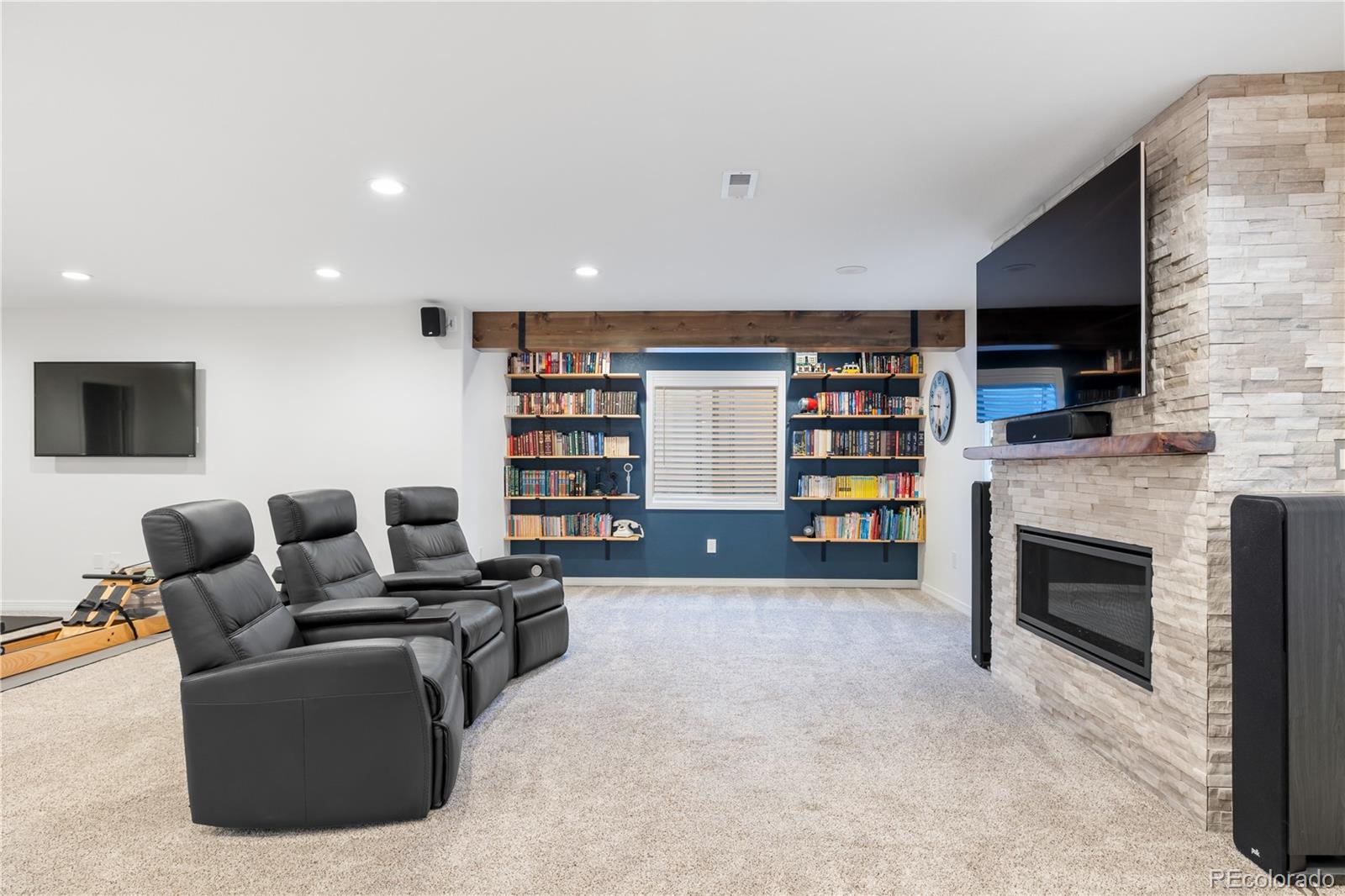 10681 Sundial Rim Road Highlands Ranch, CO 80126 - Photo 29 of 45 a living room with furniture and a fireplace