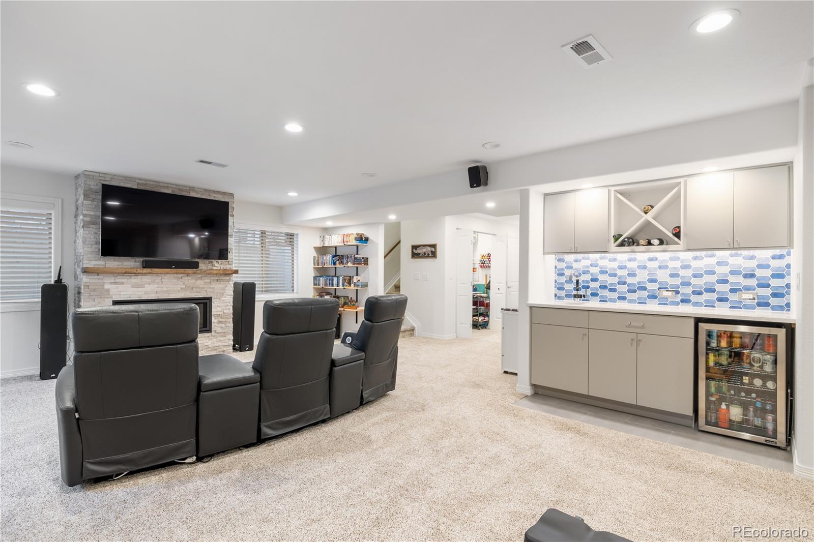 10681 Sundial Rim Road Highlands Ranch, CO 80126 - Photo 30 of 45 a living room with furniture a flat screen tv and kitchen view