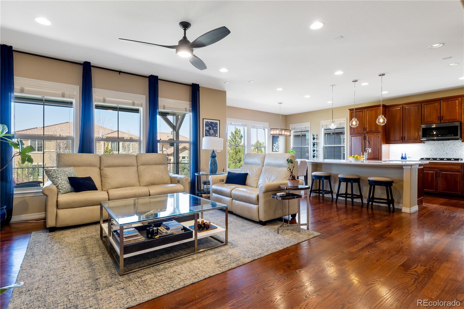10681 Sundial Rim Road Highlands Ranch, CO 80126 - Photo 3 of 45 a living room with furniture flat screen tv and a large window