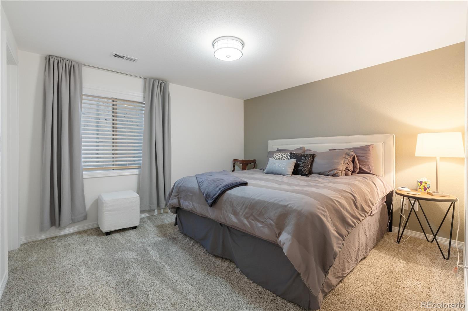 10681 Sundial Rim Road Highlands Ranch, CO 80126 - Photo 35 of 45 a bedroom with a bed and a window