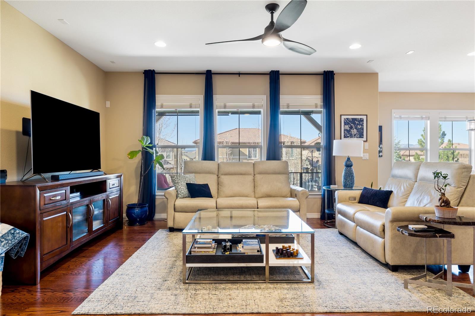 10681 Sundial Rim Road Highlands Ranch, CO 80126 - Photo 4 of 45 a living room with furniture and a flat screen tv