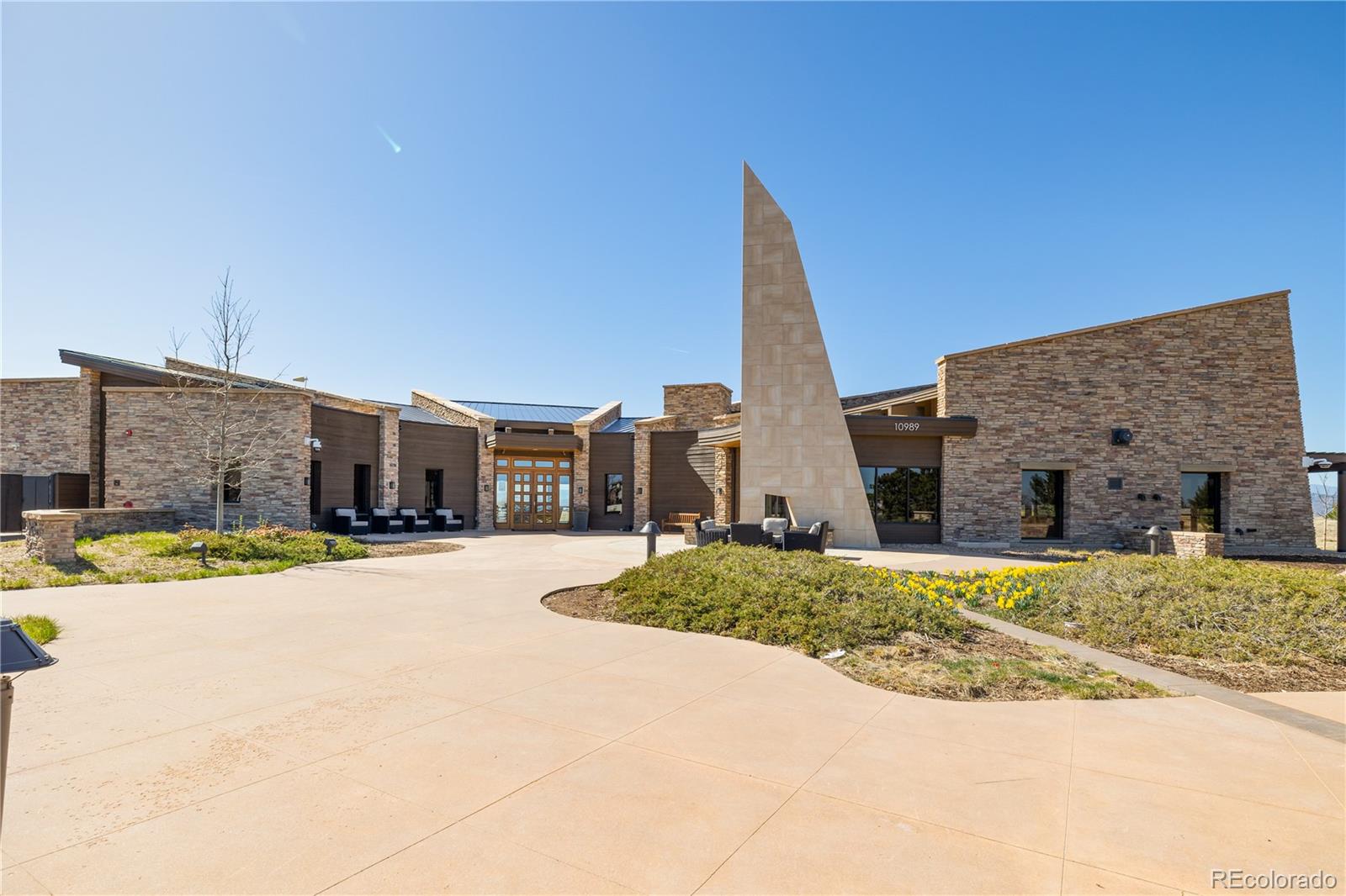 10681 Sundial Rim Road Highlands Ranch, CO 80126 - Photo 43 of 45 a view of a house with a snow on the side of a road