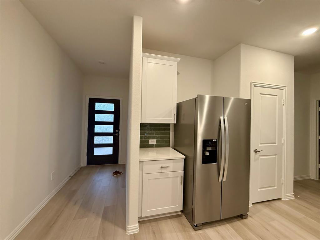 1733 Arches Road Anna, TX 75409 - Photo 5 of 17 a kitchen with stainless steel appliances a refrigerator and a stove top oven