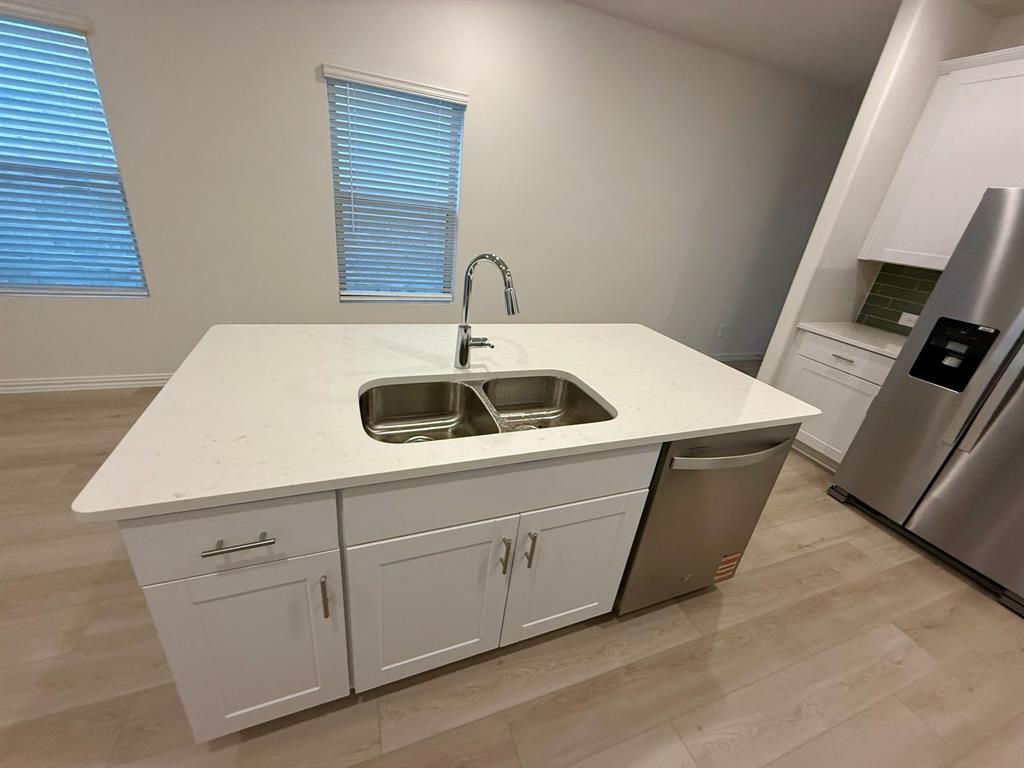 1733 Arches Road Anna, TX 75409 - Photo 6 of 17 a kitchen with sink and cabinets