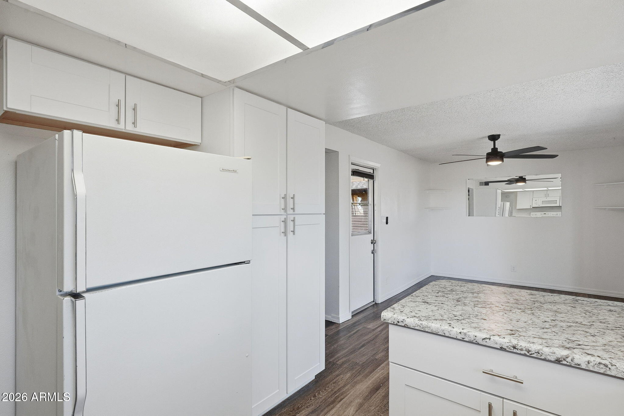 2302 East Nisbet Road Phoenix, AZ 85022 - Photo 7 of 22 a kitchen with a refrigerator and a stove top oven