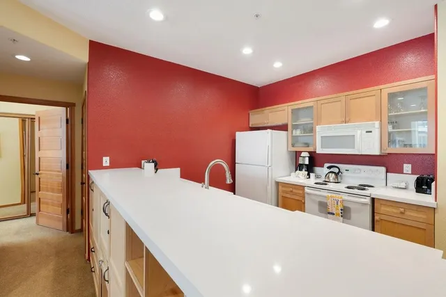 a kitchen that has a microwave a stove and a refrigerator