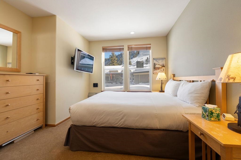 201 Shirley Cyn Road, Unit 714 Olympic Valley, CA 96146 - Photo 7 of 28 a bedroom with a bed and a flat tv screen on dresser