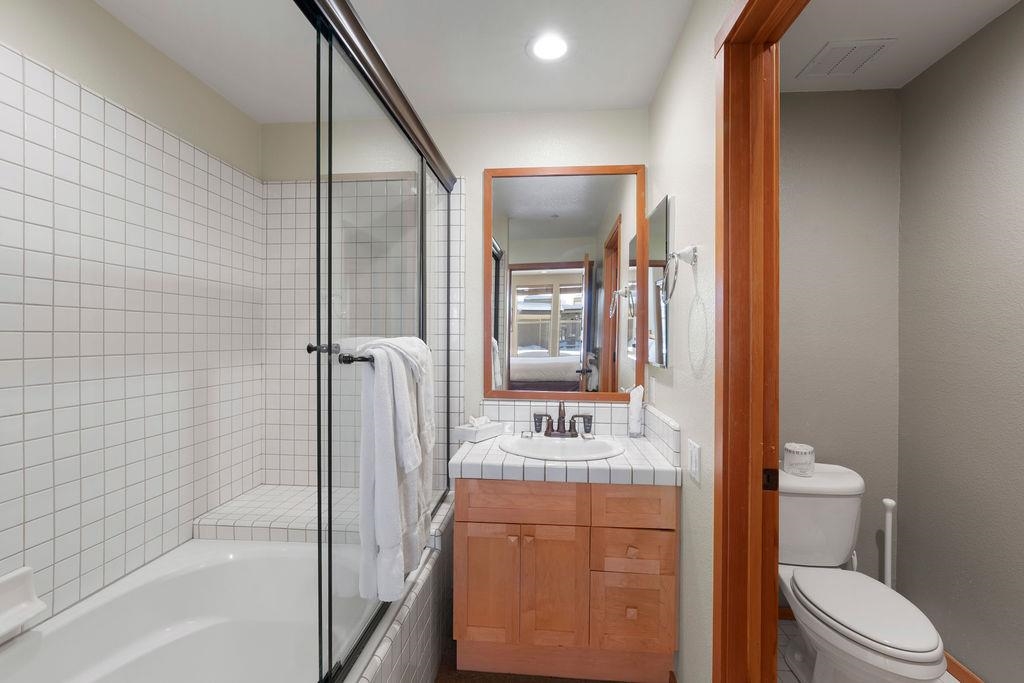 201 Shirley Cyn Road, Unit 714 Olympic Valley, CA 96146 - Photo 10 of 28 a bathroom with a toilet sink and mirror
