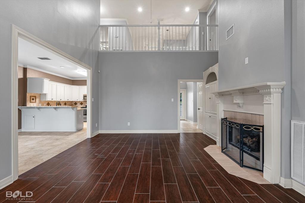 1663 Spencer Circle Benton, LA 71006 - Photo 14 of 40 a view of a livingroom with wooden floor and a kitchen