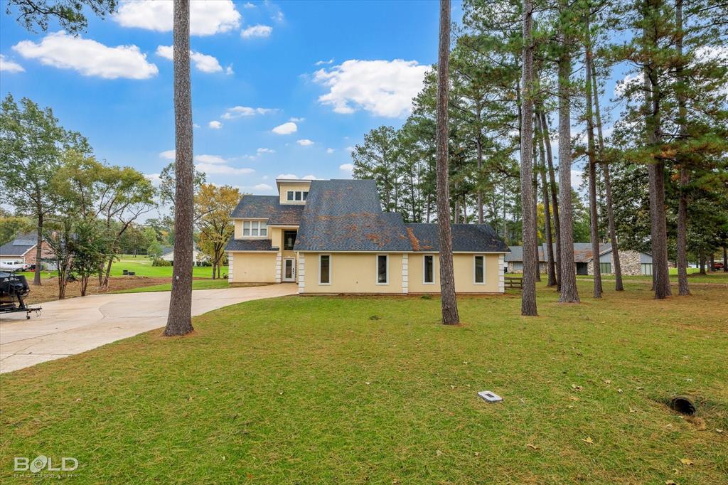 1663 Spencer Circle Benton, LA 71006 - Photo 2 of 40 a swimming pool with outdoor seating and yard