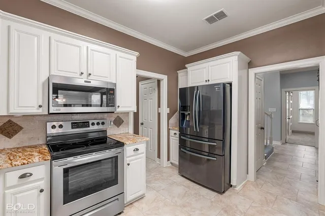 a kitchen with a stove microwave and refrigerator