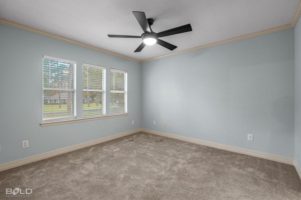 1663 Spencer Circle Benton, LA 71006 - Photo 36 of 40 an empty room with ceiling fan and windows