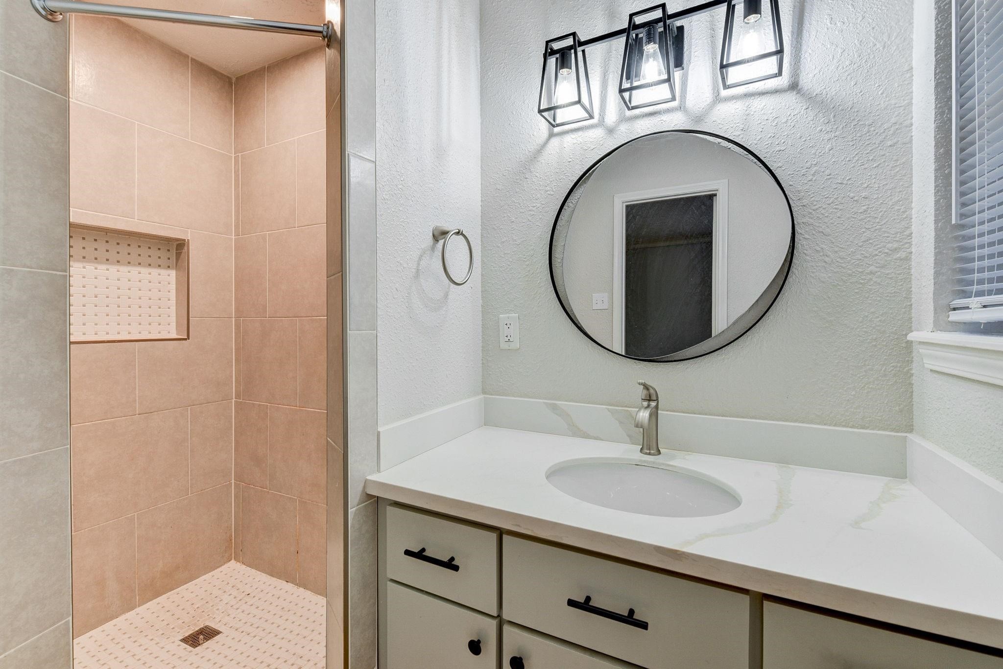 18015 Woodgum Drive Spring, TX 77388 - Photo 13 of 23 a bathroom with a sink and a mirror