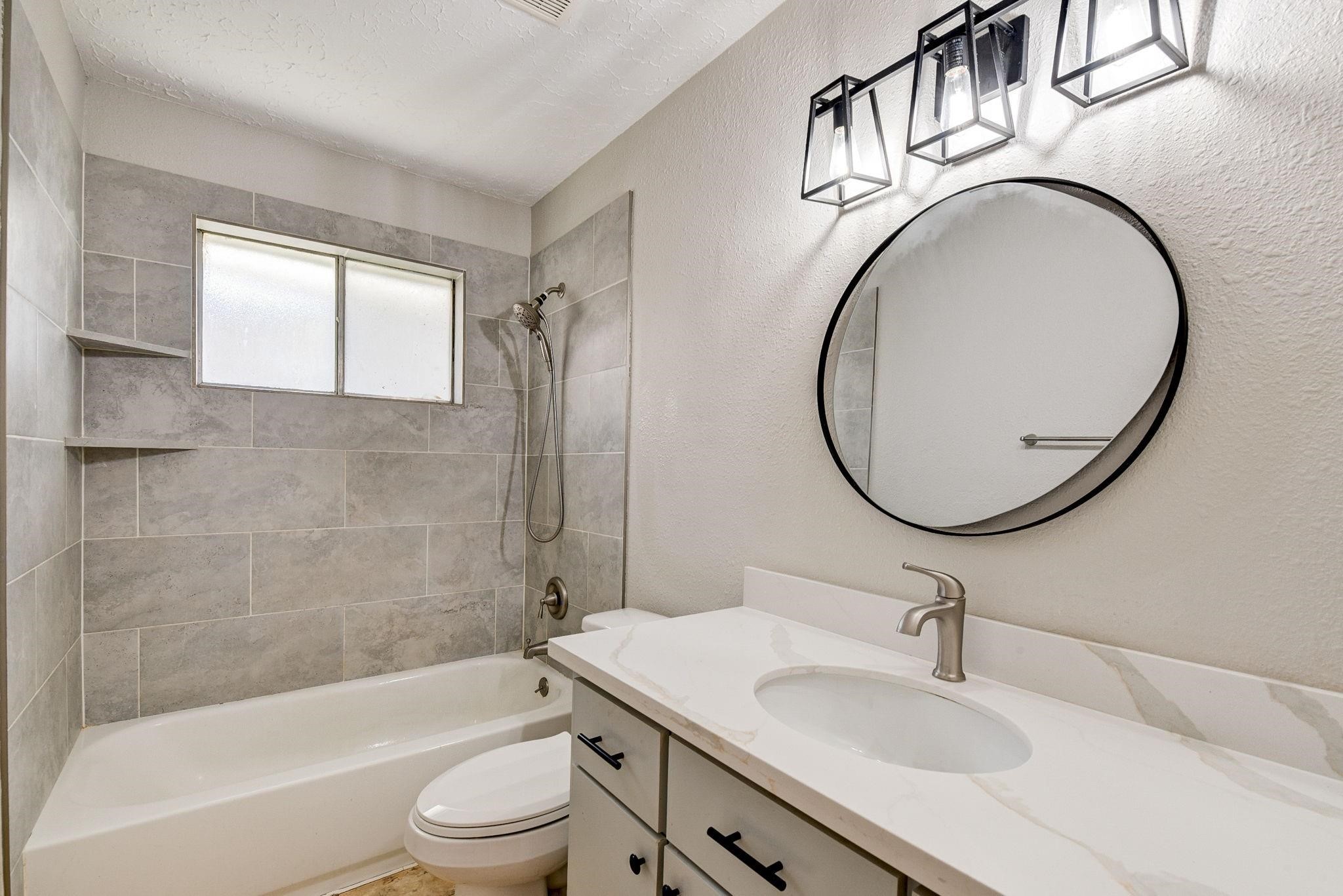 18015 Woodgum Drive Spring, TX 77388 - Photo 14 of 23 a bathroom with a sink a toilet and a mirror