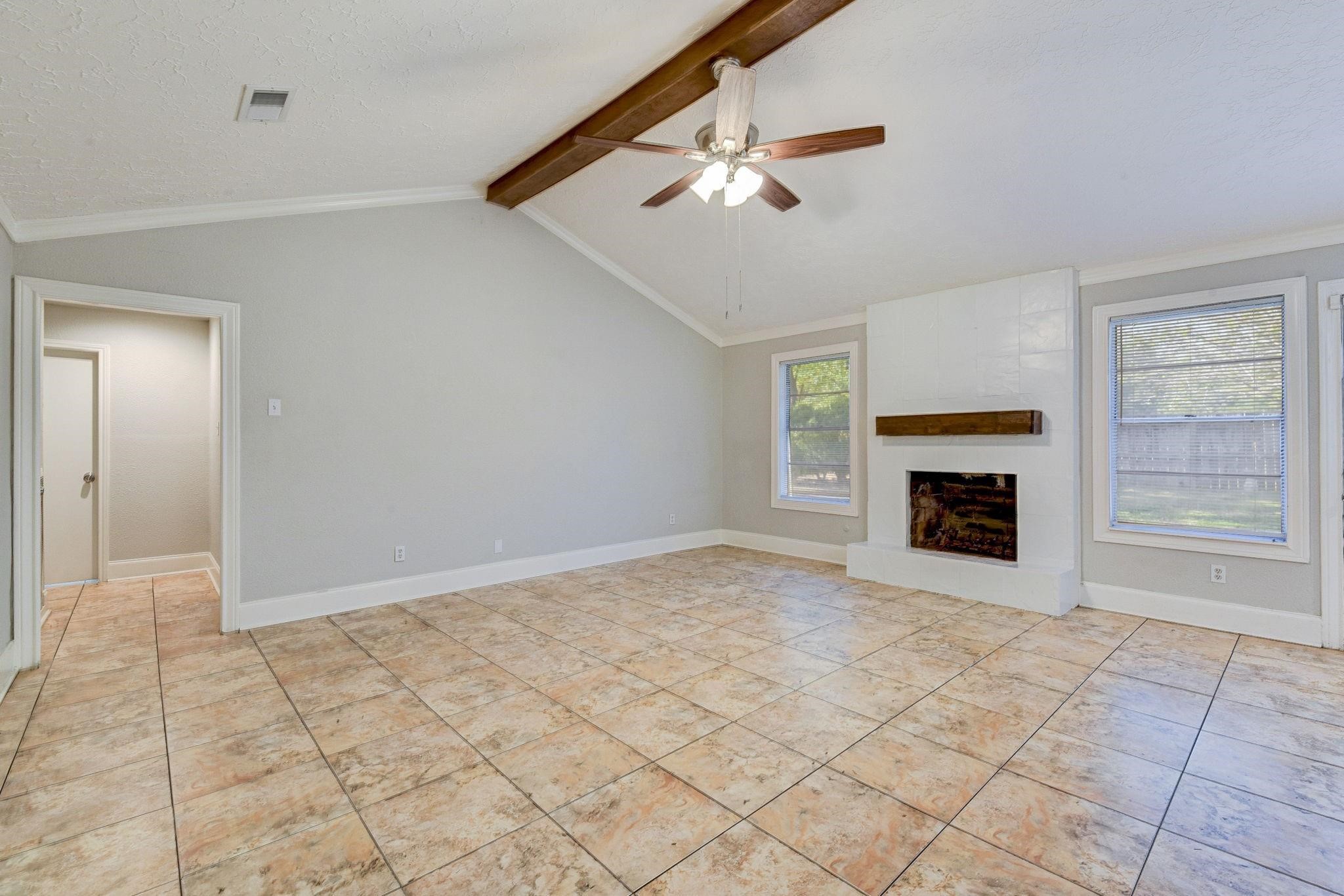 18015 Woodgum Drive Spring, TX 77388 - Photo 3 of 23 an empty room with windows and fireplace