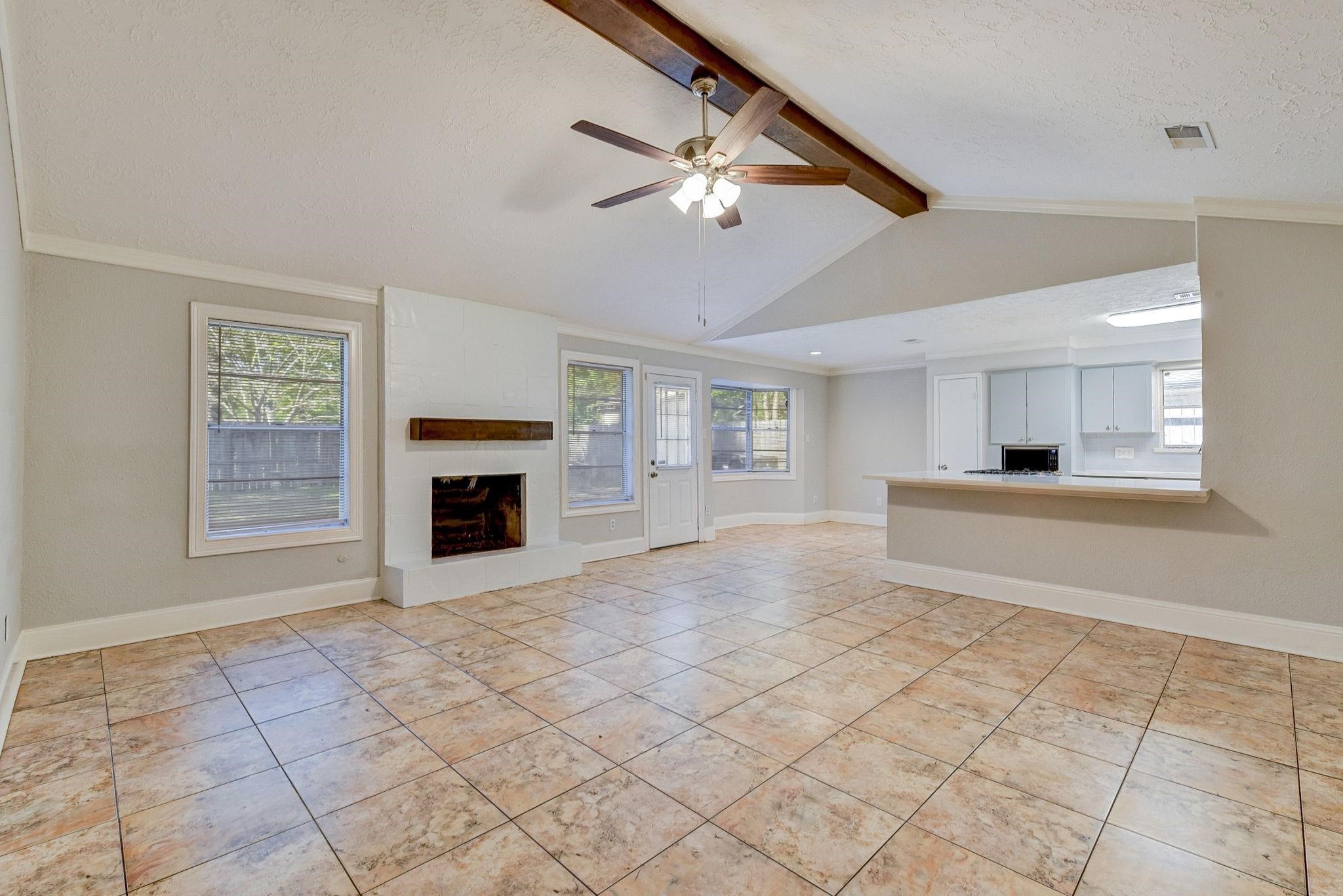 18015 Woodgum Drive Spring, TX 77388 - Photo 4 of 23 a view of an empty room with a fireplace and a window