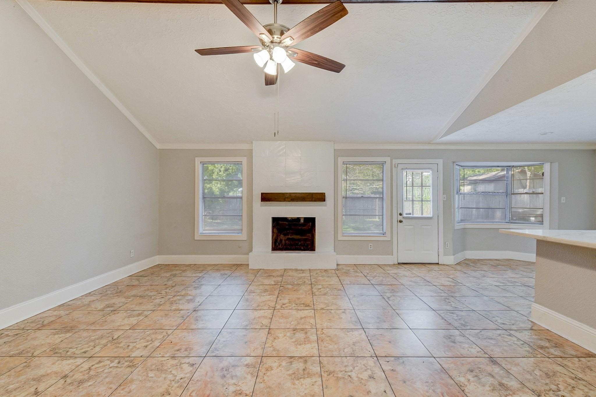 18015 Woodgum Drive Spring, TX 77388 - Photo 5 of 23 a view of an empty room with a fireplace and a window