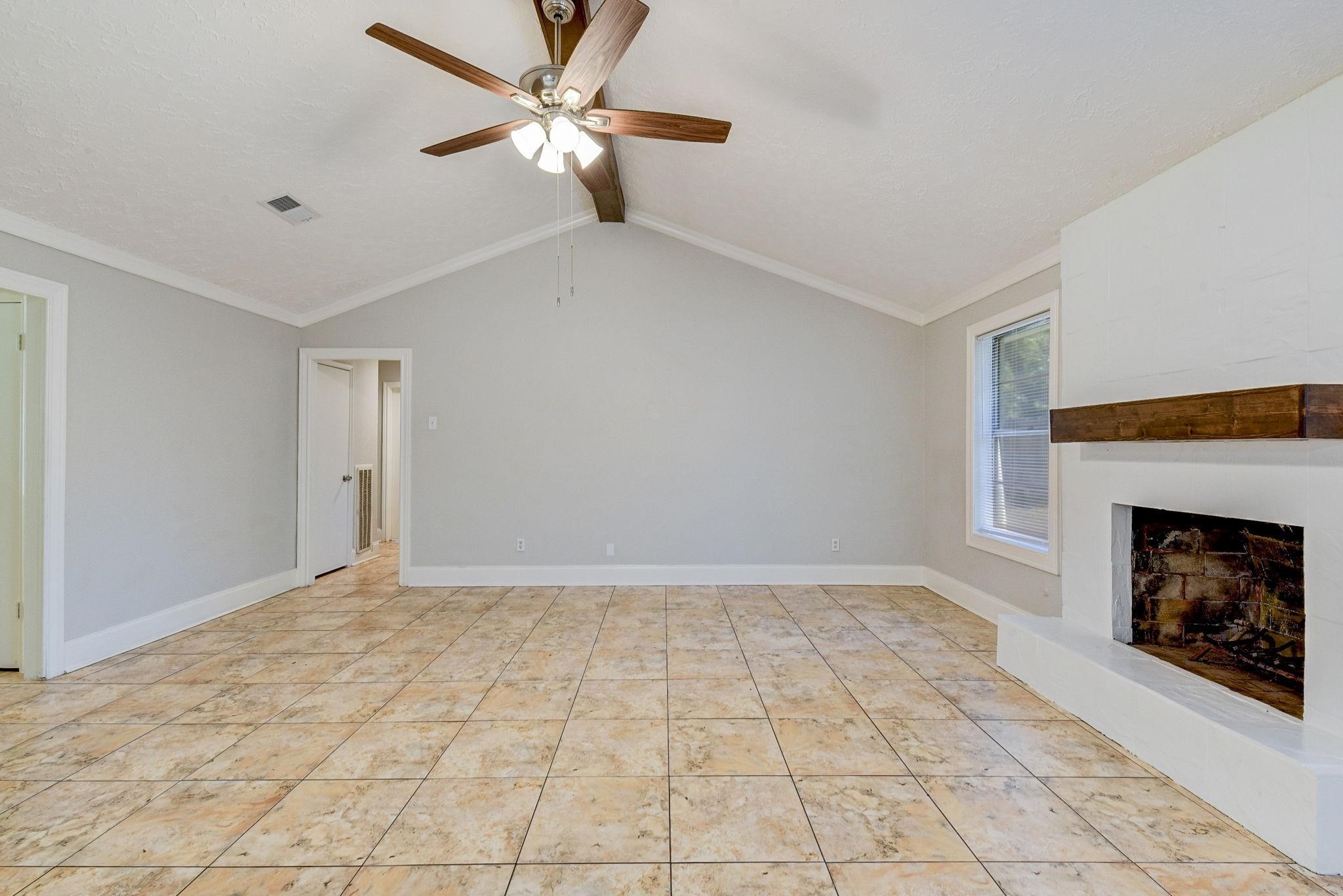 18015 Woodgum Drive Spring, TX 77388 - Photo 7 of 23 a view of an empty room with window and fireplace