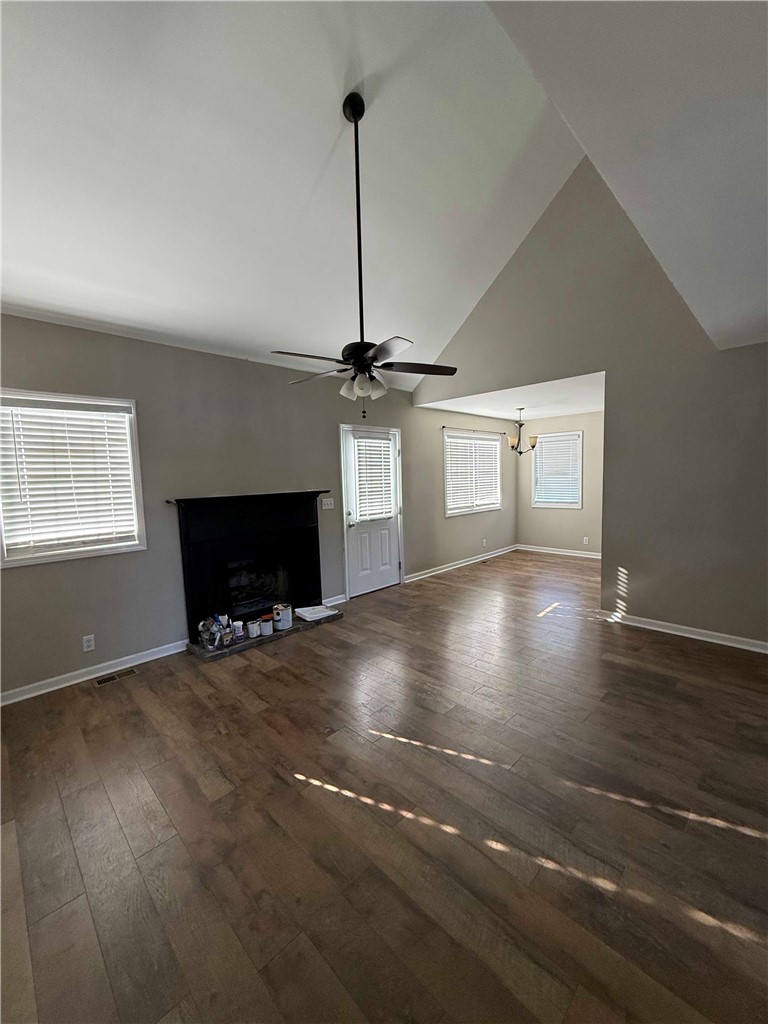 116 Kelly Lane Easley, SC 29642 - Photo 39 of 39 An open floorplan centers around a classic fireplace set beneath soaring vaulted ceilings.