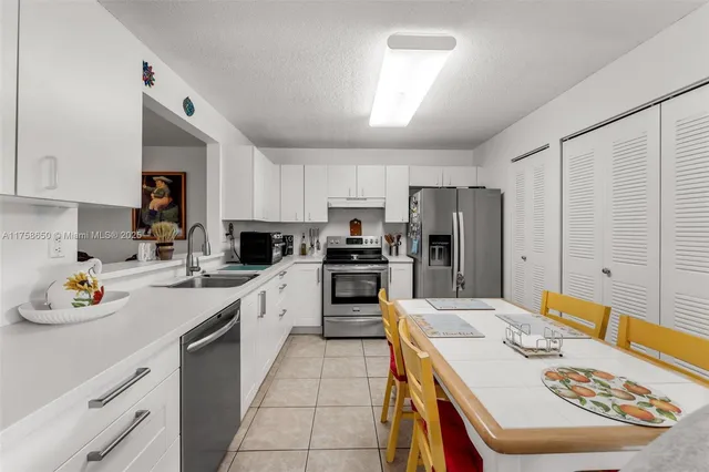 a kitchen with a sink stove and refrigerator