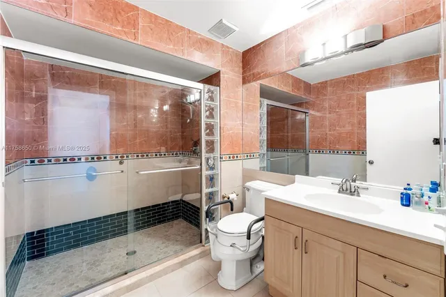 a bathroom with a sink toilet and shower