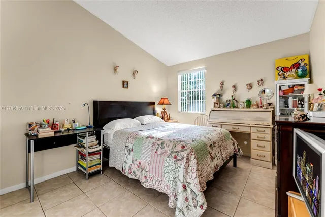 a bedroom with a bed and dresser