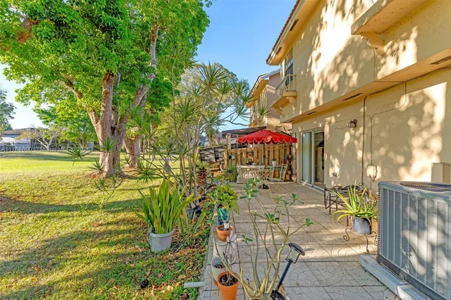 a view of a patio with table and chairs and potted plants
