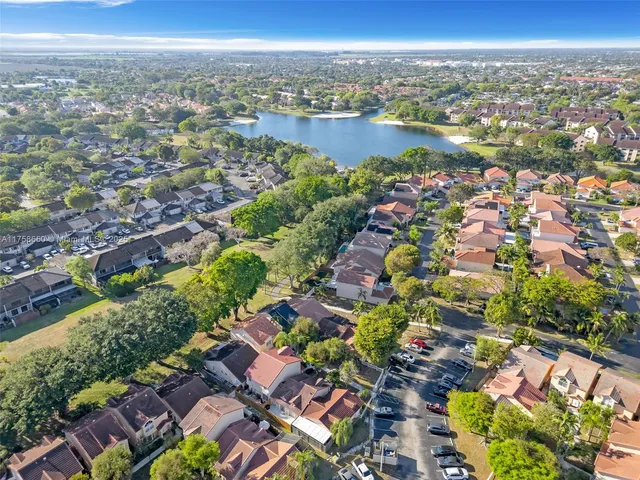 an aerial view of a city with lots of residential buildings and mountain view in back