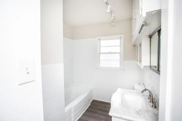 a bathroom with a tub sink and window