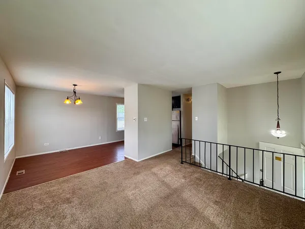 an empty room with closet and windows