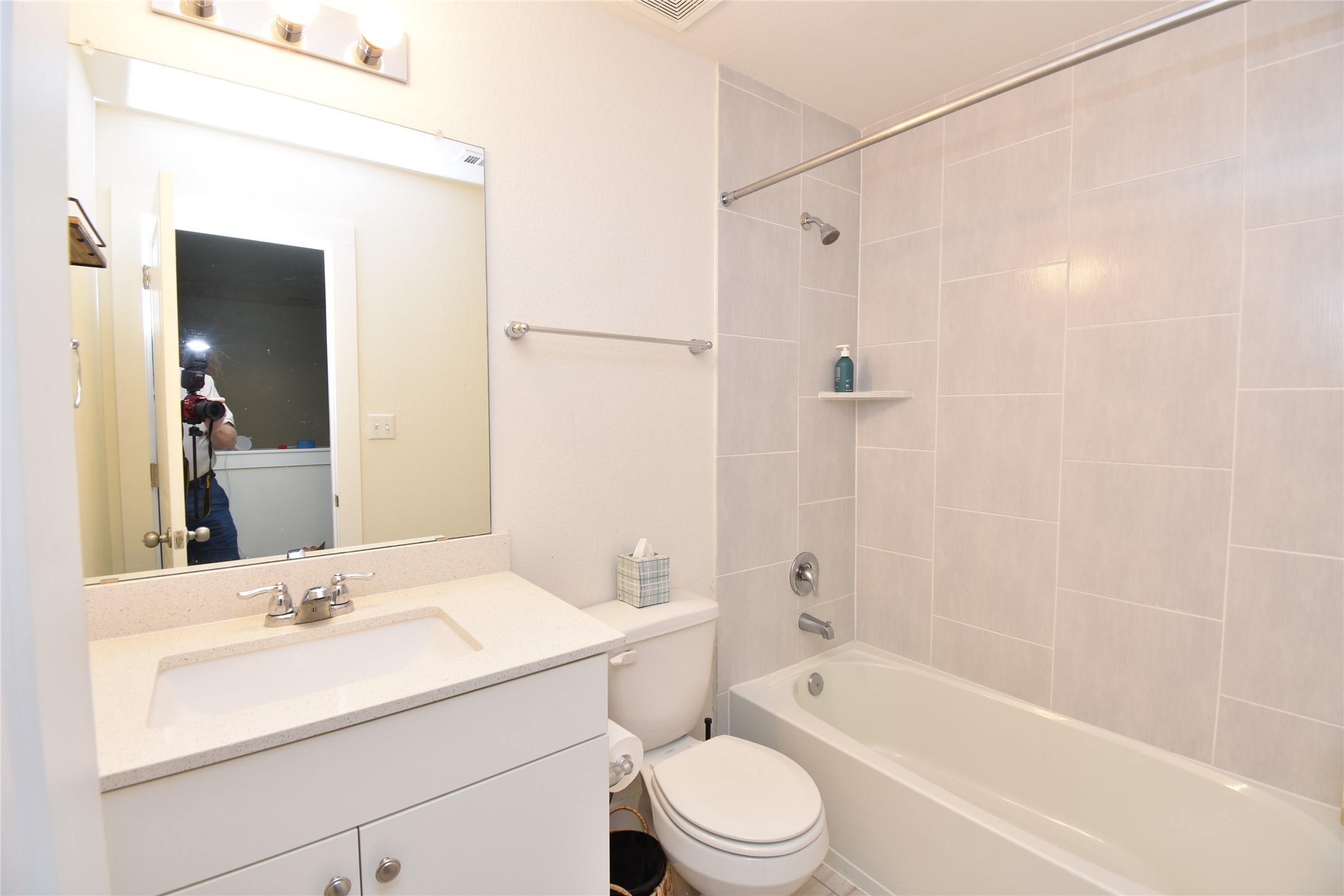 331 Alamar Knot Way, Unit 208 Georgetown, TX 78626 - Photo 5 of 17 A well-appointed bathroom features a modern vanity with a wide sink and a tiled shower-over-tub combination.