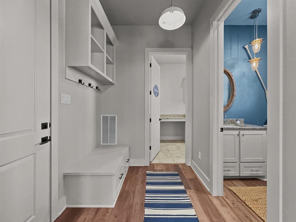 1044 Chapel Ridge Road Graford, TX 76449 - Photo 14 of 34 a view of a hallway with wooden floor and staircase