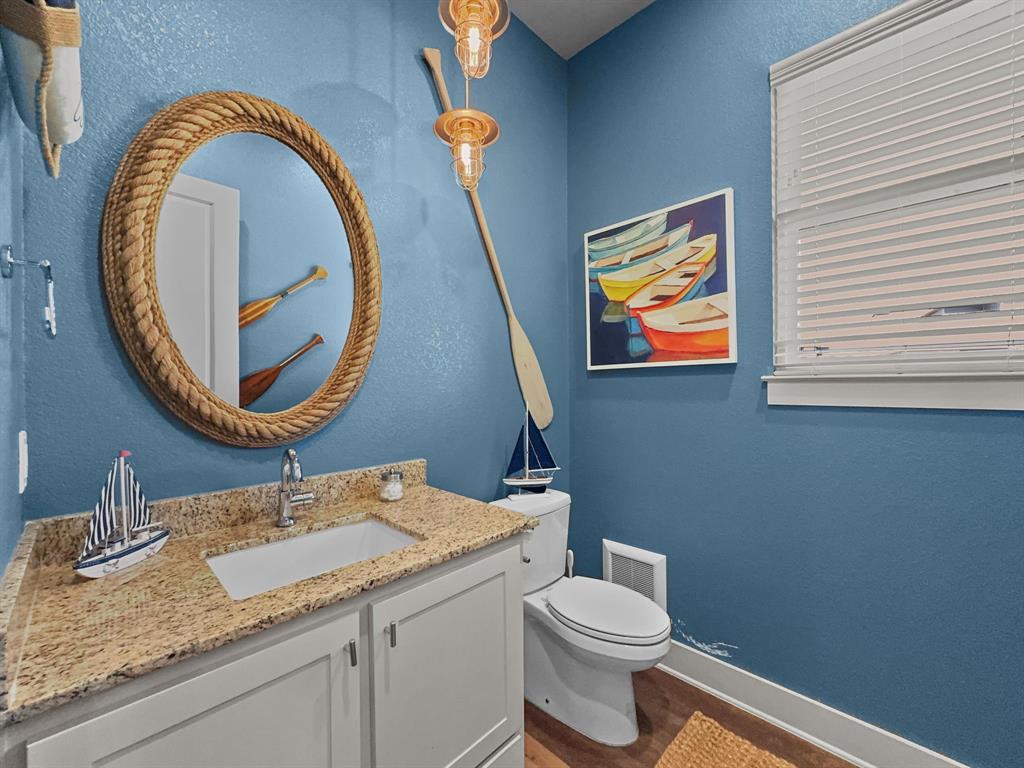 1044 Chapel Ridge Road Graford, TX 76449 - Photo 15 of 34 a bathroom with a granite countertop toilet a sink and a mirror