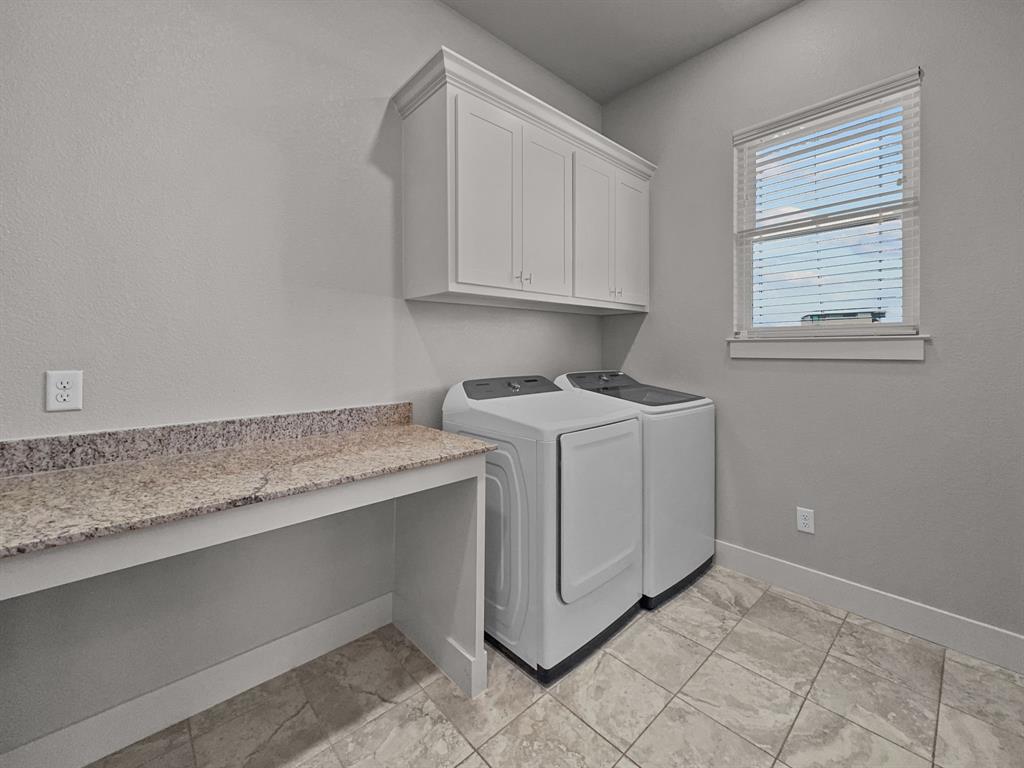 1044 Chapel Ridge Road Graford, TX 76449 - Photo 16 of 34 a utility room with granite countertop cabinets washer and dryer