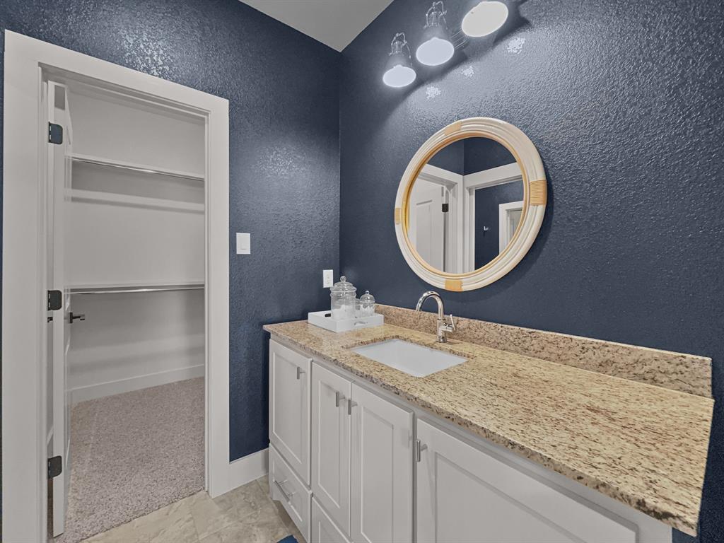 1044 Chapel Ridge Road Graford, TX 76449 - Photo 24 of 34 a bathroom with a granite countertop sink and a mirror