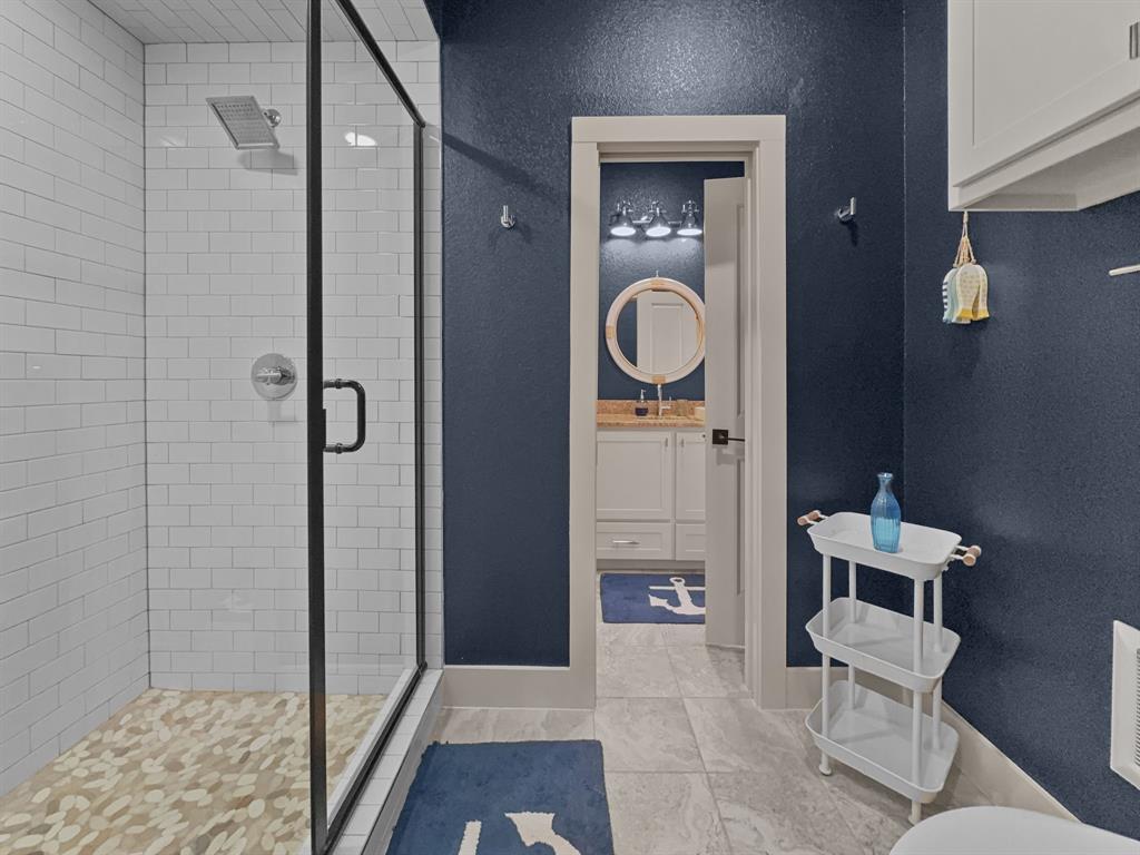 1044 Chapel Ridge Road Graford, TX 76449 - Photo 25 of 34 a bathroom with a toilet and a shower