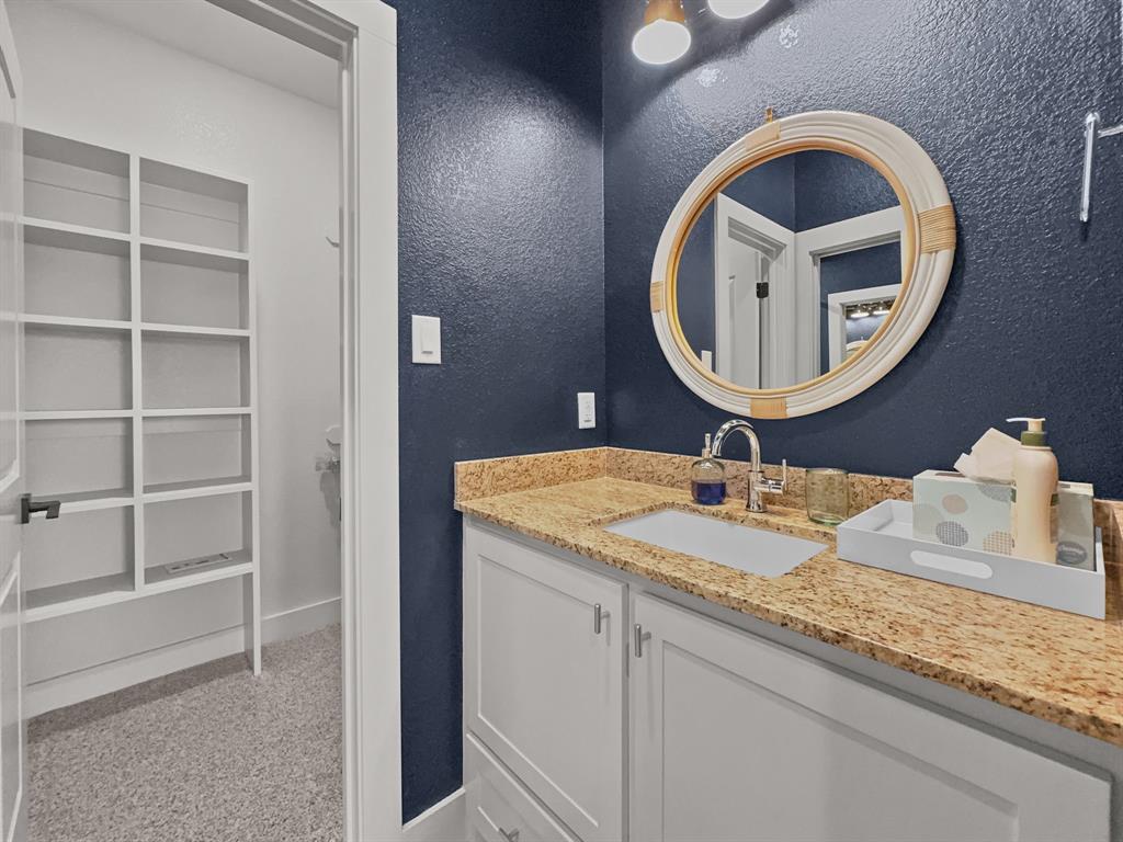 1044 Chapel Ridge Road Graford, TX 76449 - Photo 26 of 34 a bathroom with a granite countertop sink and a mirror