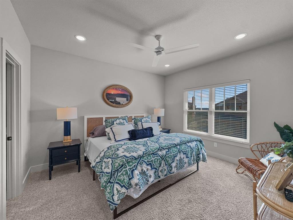 1044 Chapel Ridge Road Graford, TX 76449 - Photo 27 of 34 a bedroom with a large bed and a large window