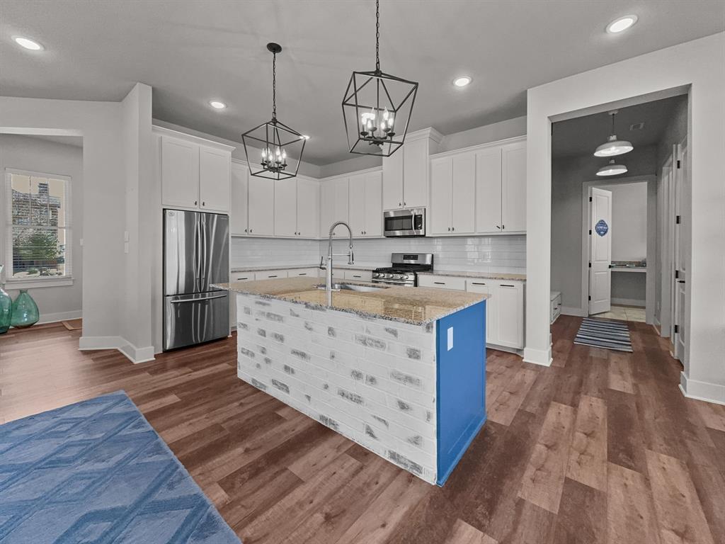 1044 Chapel Ridge Road Graford, TX 76449 - Photo 9 of 34 a kitchen with kitchen island a sink stove and refrigerator