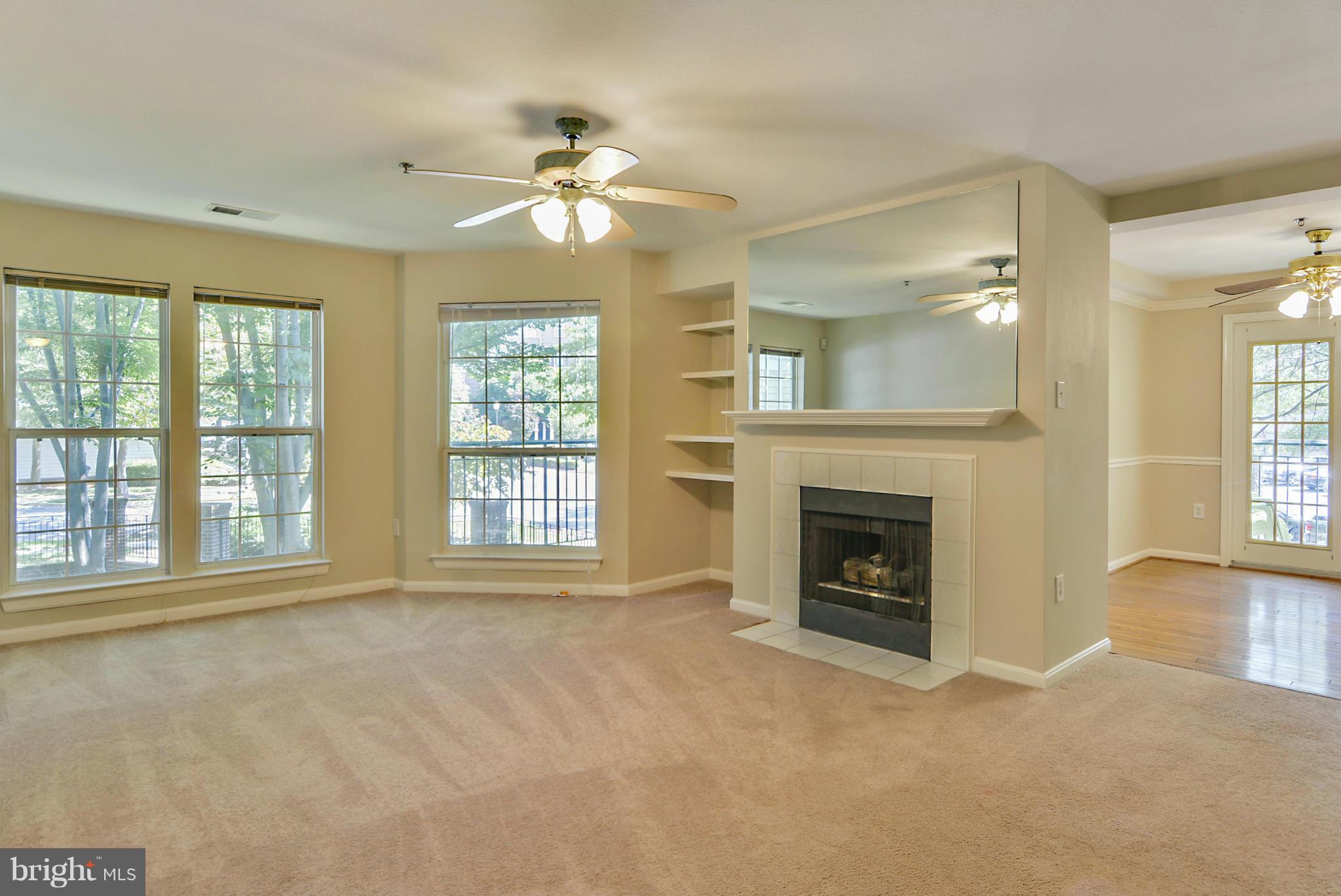 110 Booth Street, Unit 28 Gaithersburg, MD 20878 - Photo 2 of 30 a view of an empty room with a fireplace and a window
