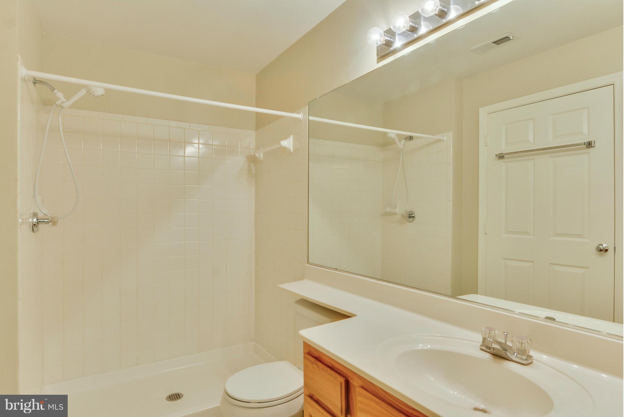 110 Booth Street, Unit 28 Gaithersburg, MD 20878 - Photo 13 of 30 a bathroom with a sink toilet and shower